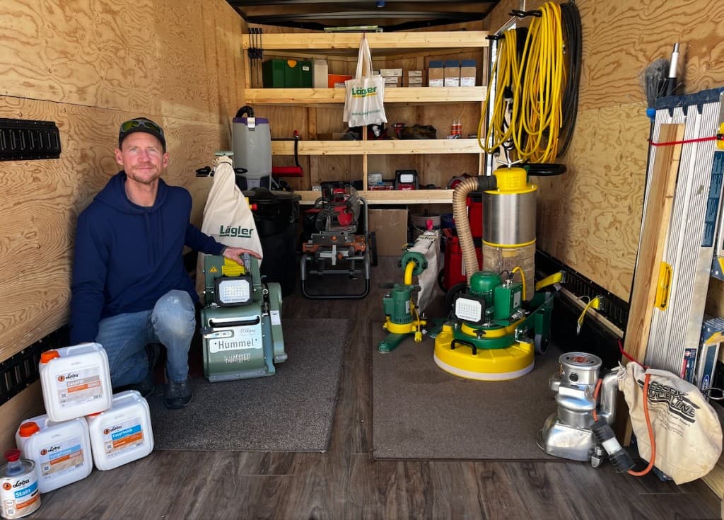 Jared inside his mobile workshop trailer with professional floor sanding equipment