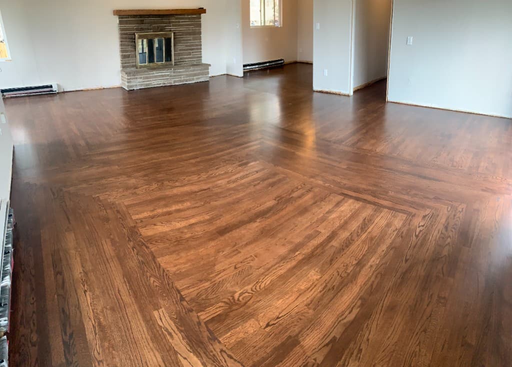 Evenly toned restored hardwood floors in a Cody Wyoming living room after professional refinishing